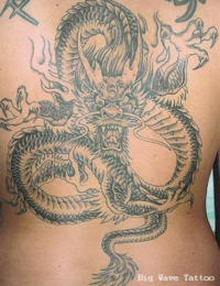 Großflächiges japanisches Rückentattoo eines Drachen (Ryu) in Black-and-Grey. Das Motiv zeigt den Drachen mit geöffnetem Maul, Krallen und detailreichen Schuppenstrukturen, der sich in weiten Windungen über den mittleren und unteren Rücken erstreckt, gestochen von BIG WAVE TATTOO PRIVATE & ART.